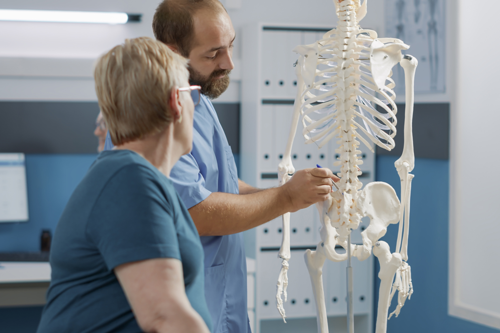 Médico con una paciente con osteoporosis