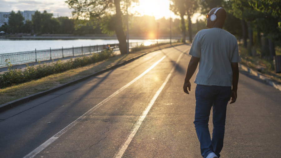 Hombre paseando bajo la luz del sol de la mañana buena para su salud
